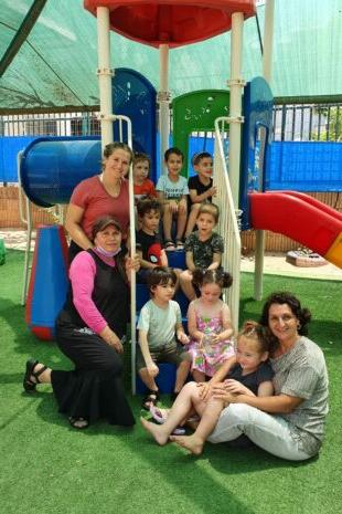 W&J Senior Hailey Nudelman stands in a playground with her students in Israel.
